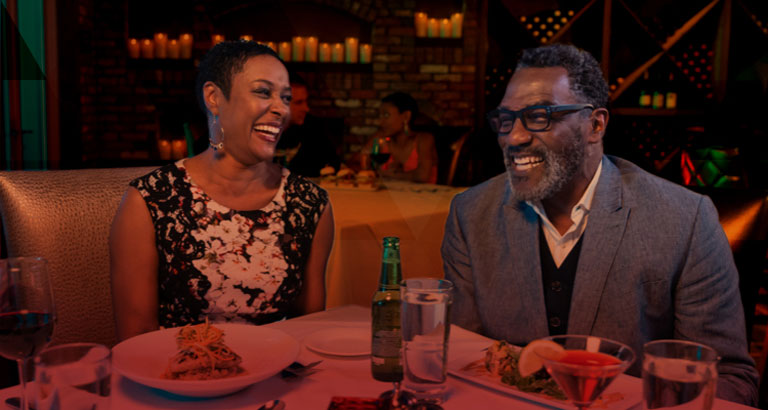 a couple laughing over dinner at Itta Bena